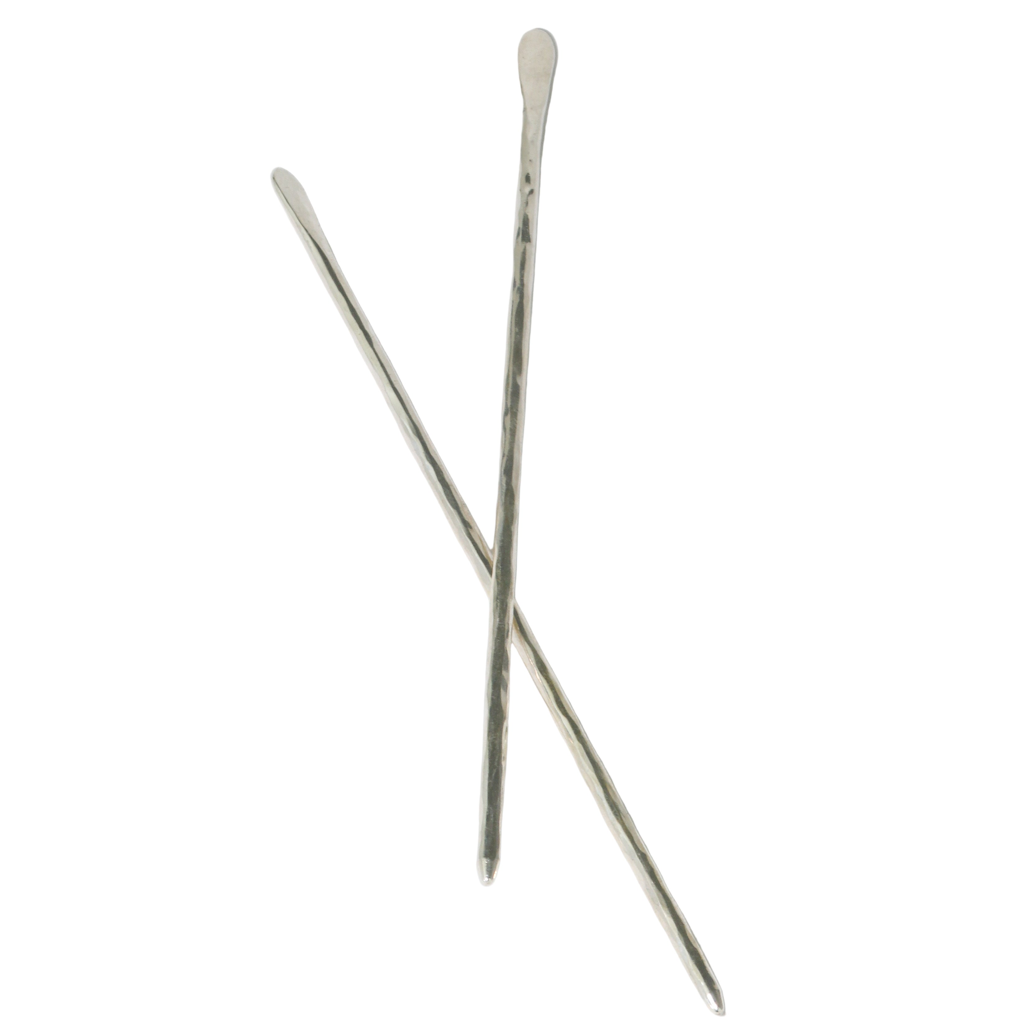 Two silver hairpins on a white background