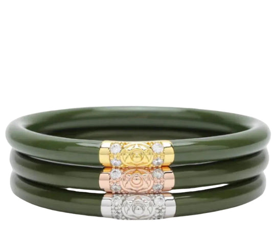 Set of green bangles with gold, silver, and rose gold accents on a light gray background