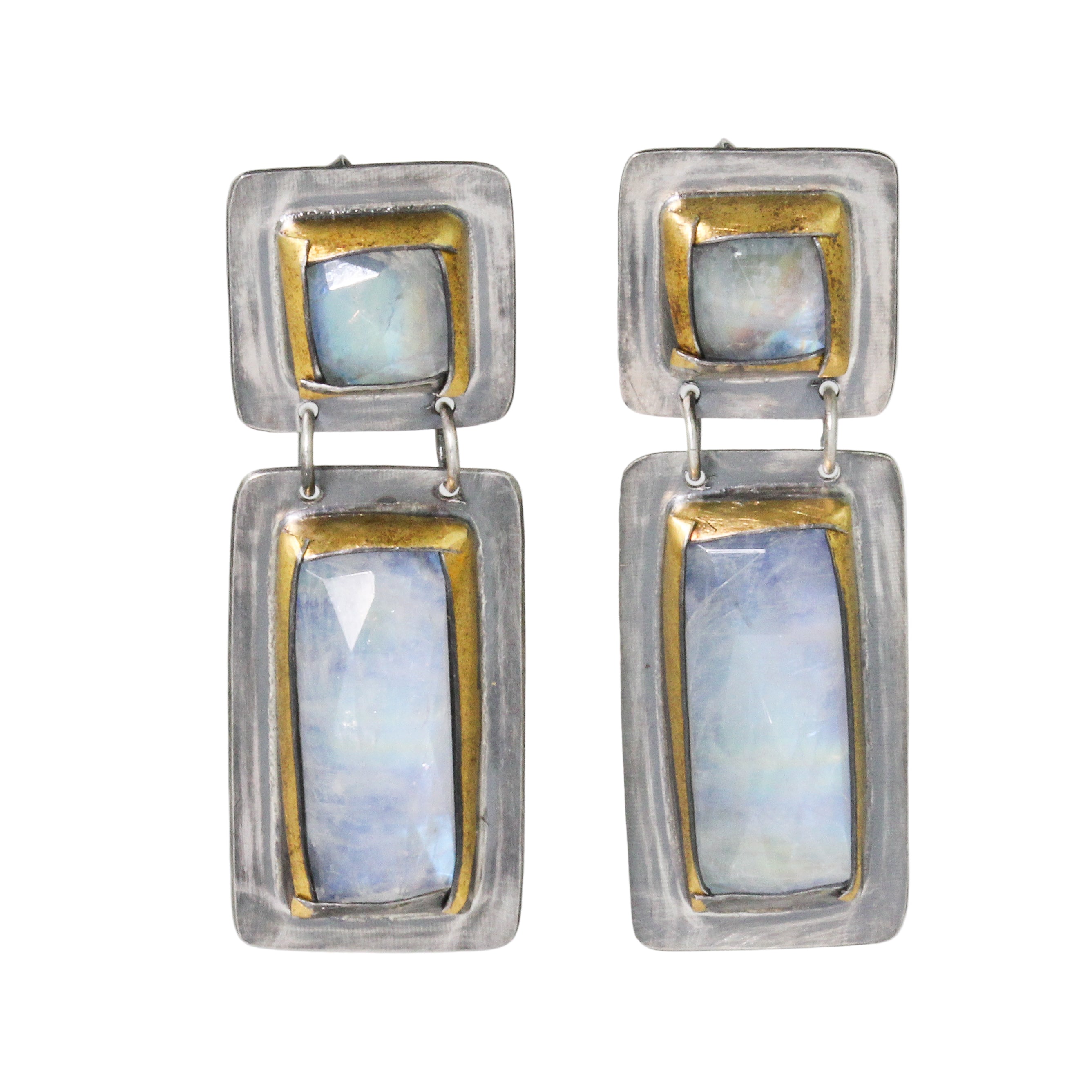 Pair of earrings with rectangular stones and gold accents on a white background