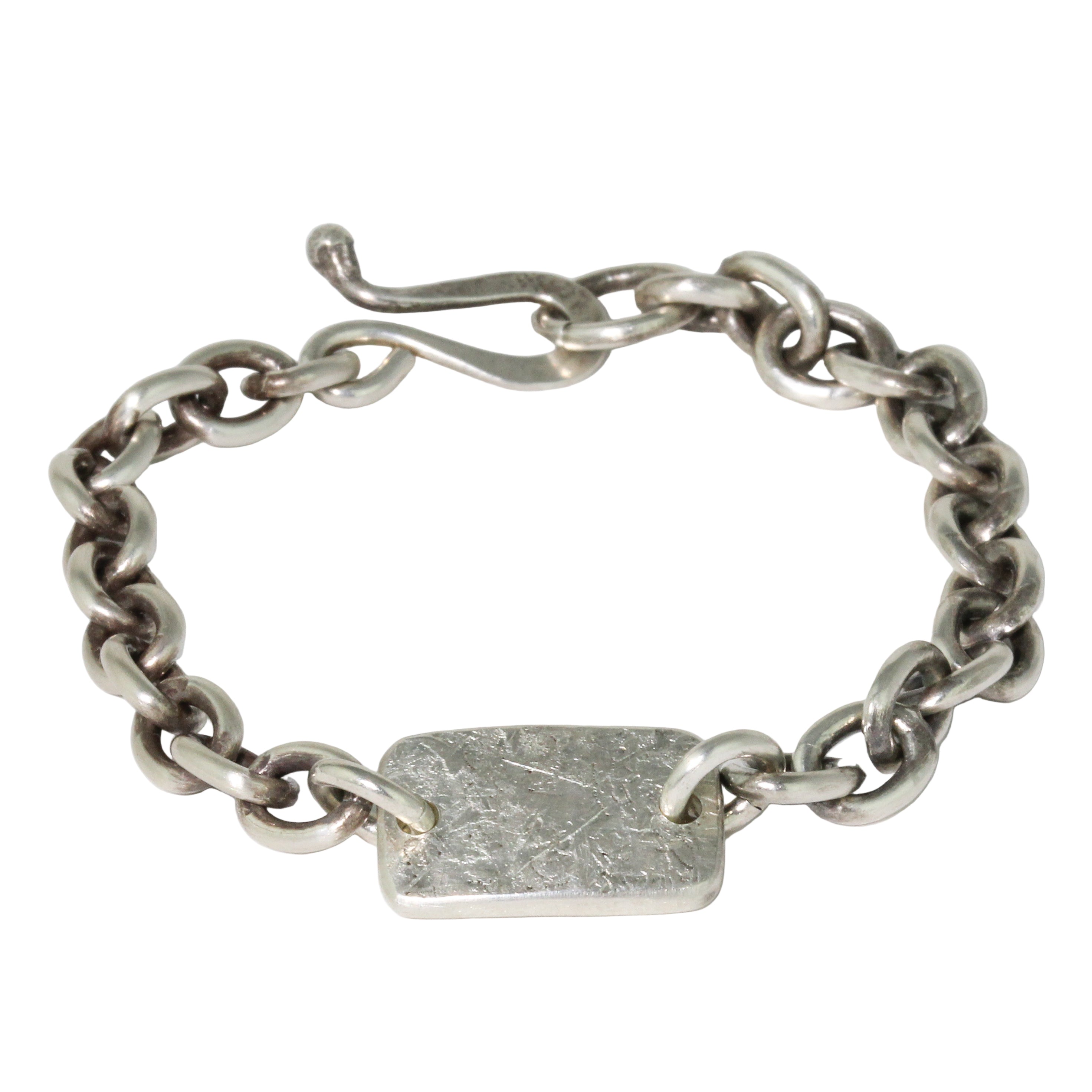Silver chain bracelet with a rectangular tag on a white background