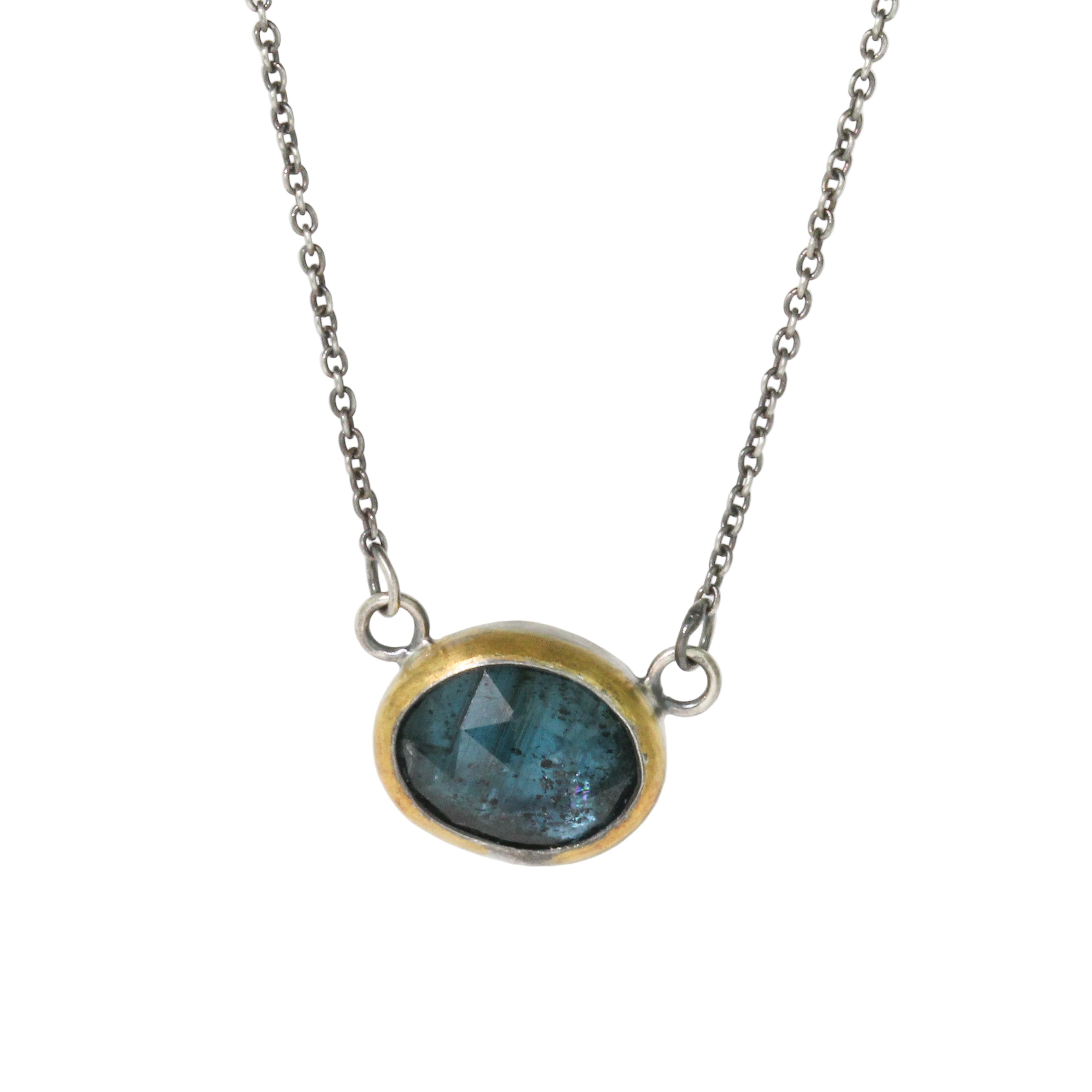 Necklace with a blue gemstone pendant on a white background