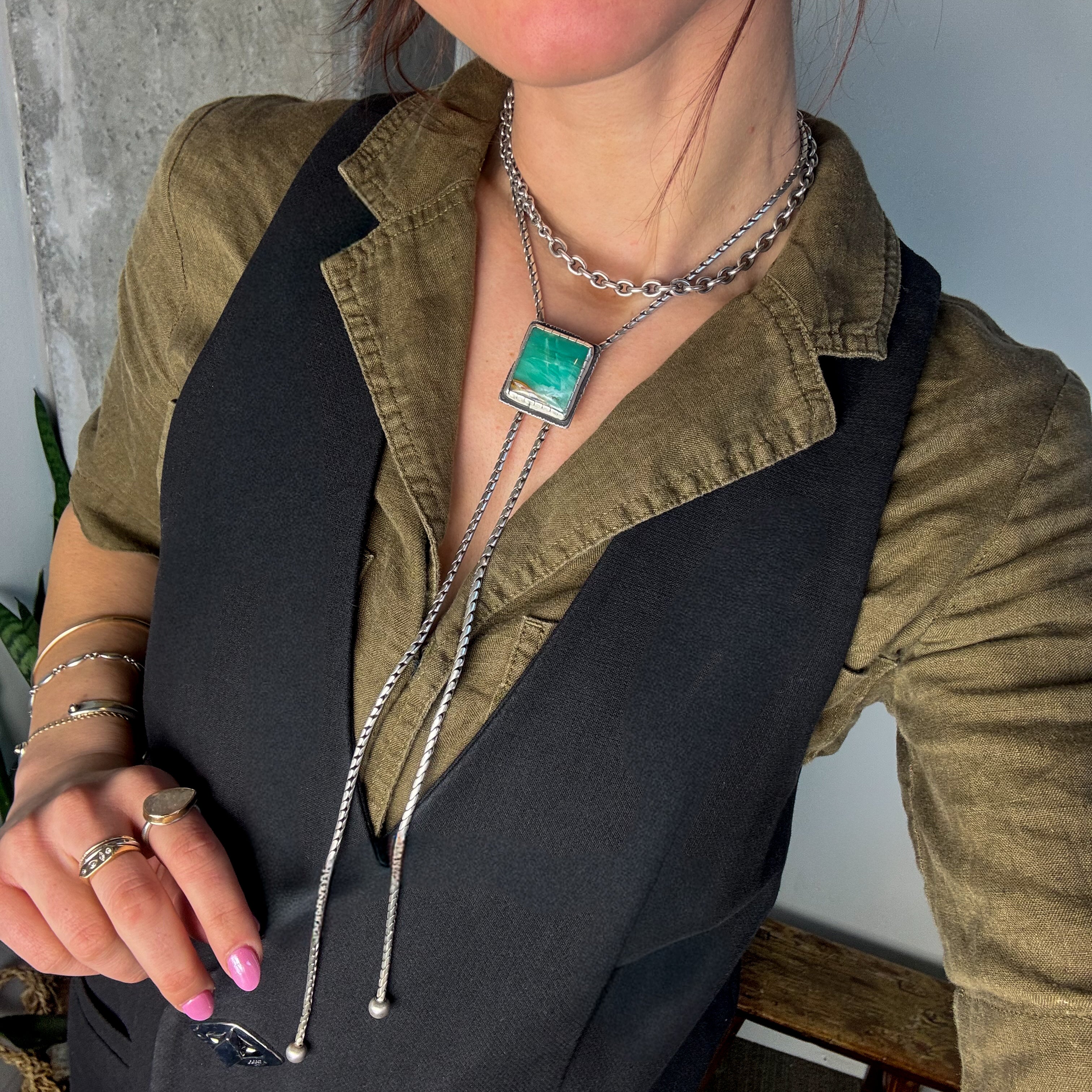 glacier lily Indonesian bolo necklace modeled on a woman layered with a chunky choker necklace