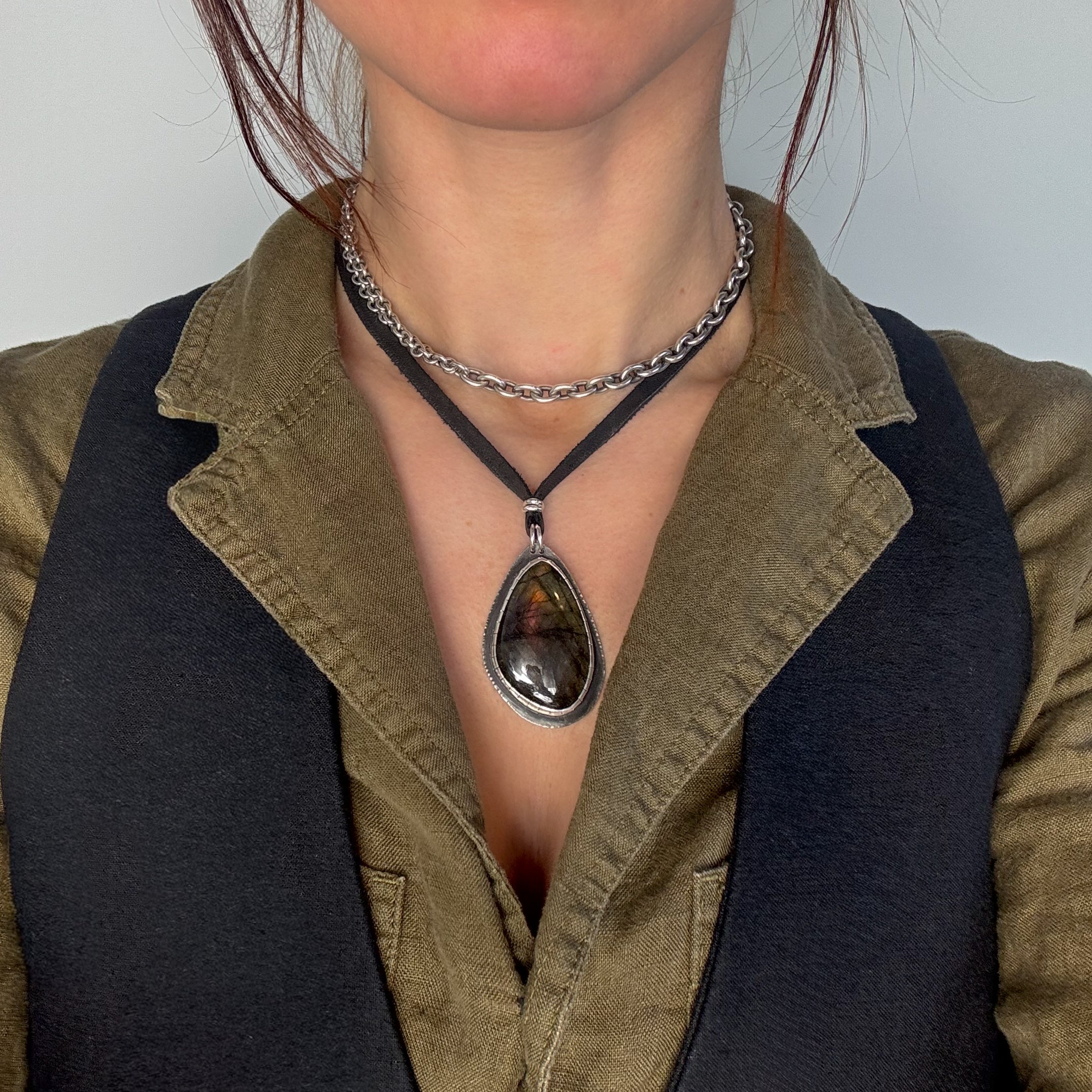 glacier lily labradorite leather necklace modeled on a woman with pendant adjusted on a shorter setting 